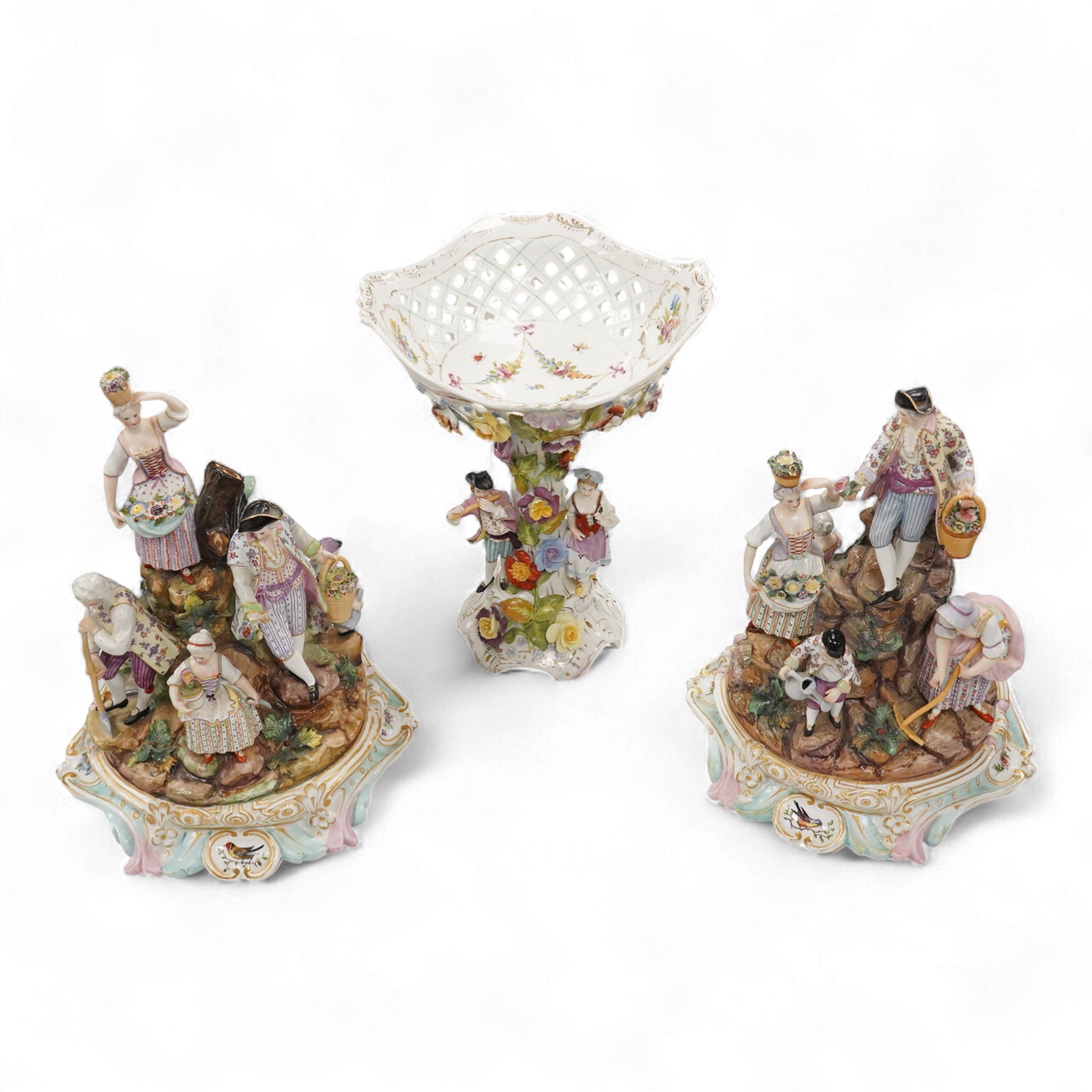 A pair of German porcelain figure groups, late 19th century and a Dresden centrepiece bowl-29cm high